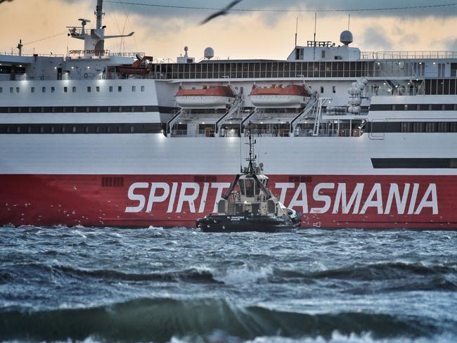 Spirit of Tasmania needs a little help from a couple of tugs in Port Melbourne during high winds. Picture: Tony Gough