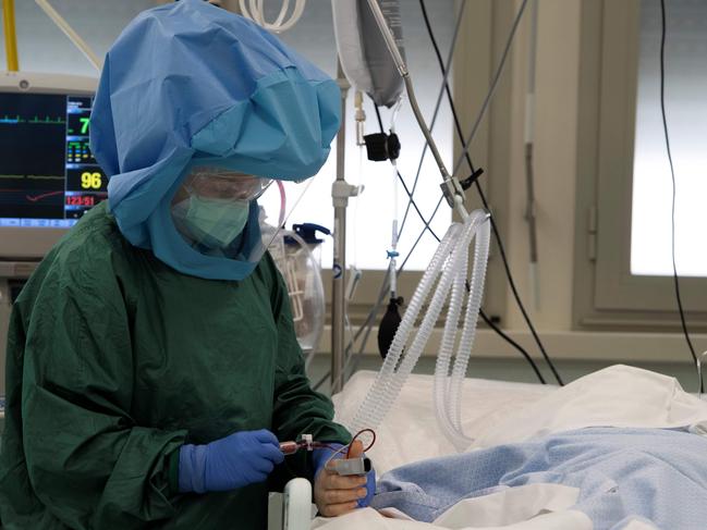 A health worker looking after a patient in intensive care. Picture: AFP