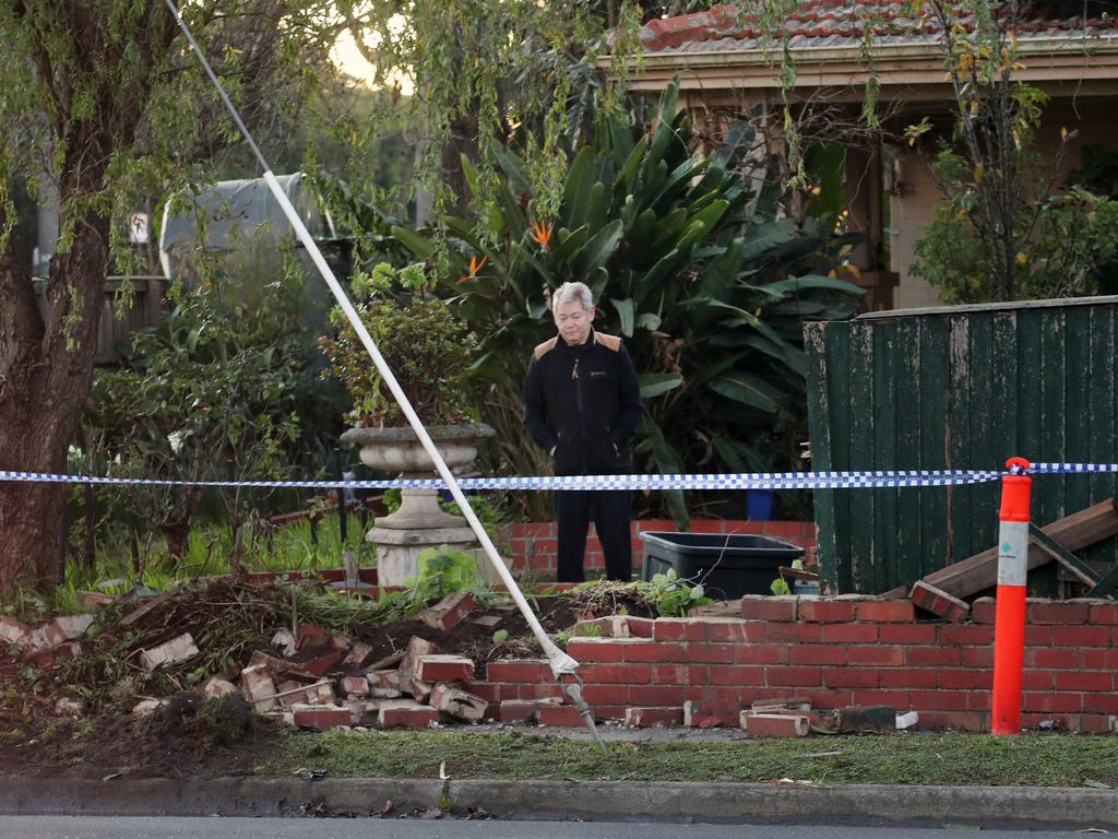 The brick fence lies in ruins after the crash. Picture: David Crosling