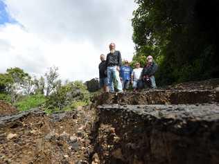 Concerned residents at Oakey Creek Road in July 2018, which is one of the many roads still needing repair after the 2017 floods. Picture: Marc Stapelberg