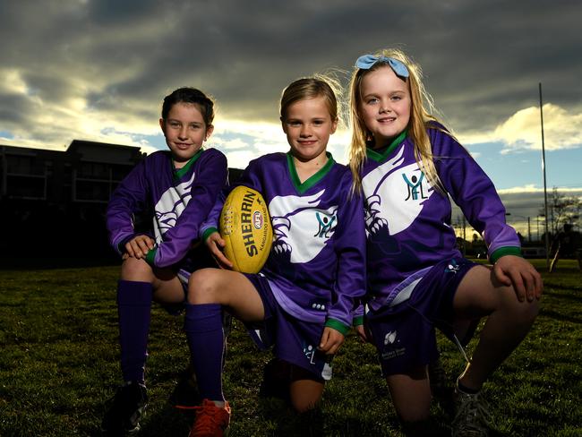 Julia, Eleanor and Eleanor love their footy. Picture: James Ross