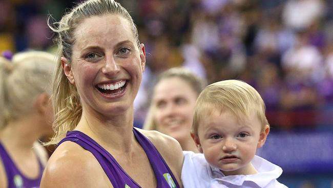 Laura Geitz with her son, Barney after a Firebirds win in July. The former Diamonds player has called time on her netball career. Picture: Jono Searle/Getty