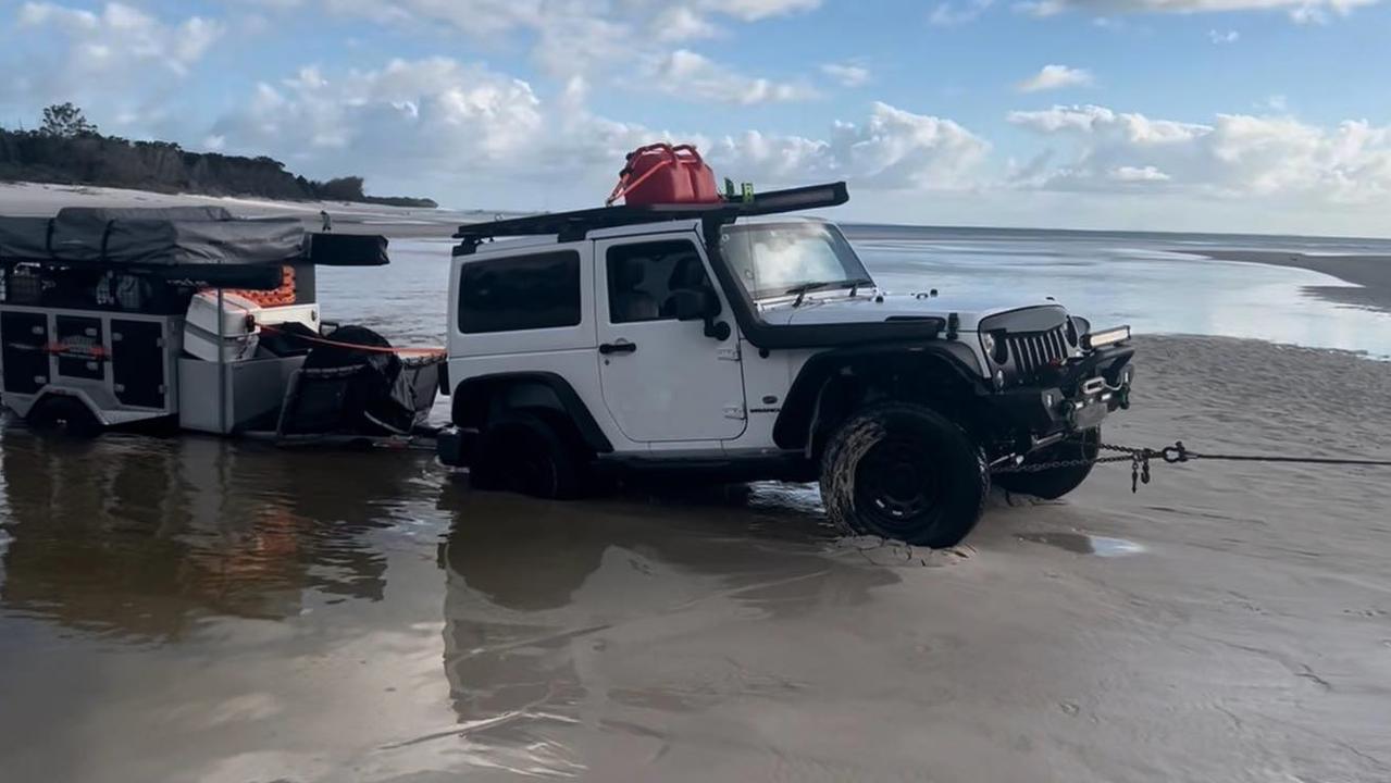 The car and camper were swamped, and a boat can be seen floating just meters from the vehicle. Picture: Fraser Island Towing