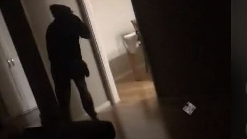 Another man is filmed inside a house with a mask.