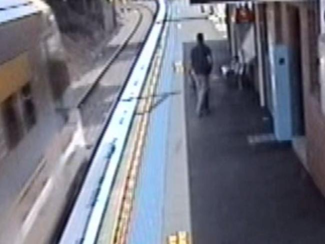 The train flies into the station seconds after the child was pulled up from the tracks.