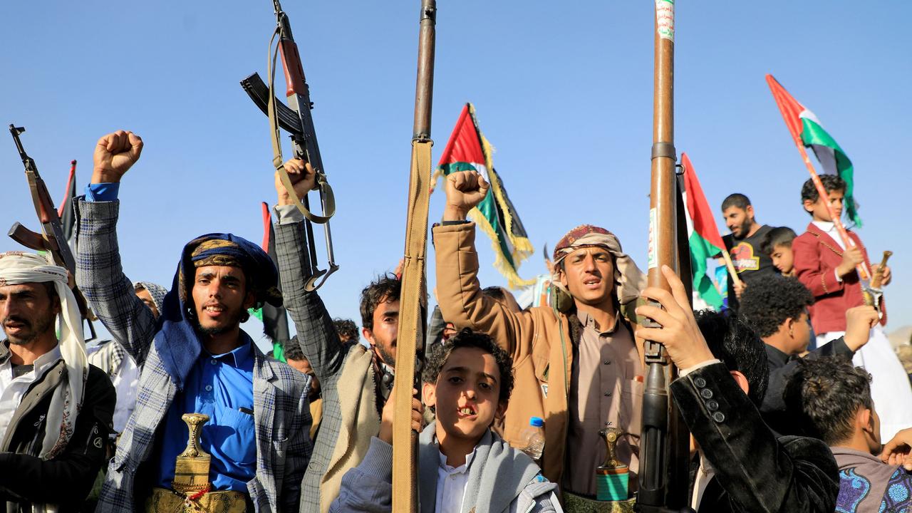 Huthi fighters brandish their weapons during a protest following US and British forces strikes in the Huthi-controlled capital Sanaa. Picture: AFP