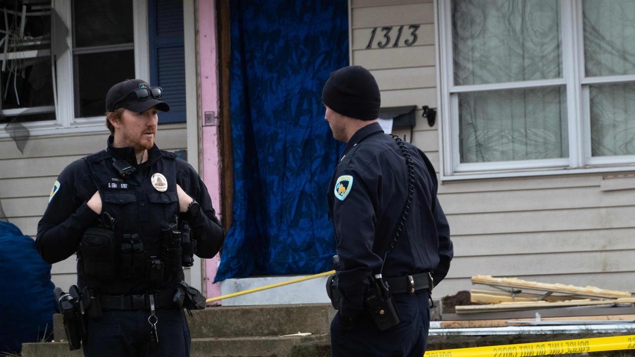 Police stand guard outside Rupnow’s family home following the school shooting in Madison, Wisconsin. Picture: AFP.