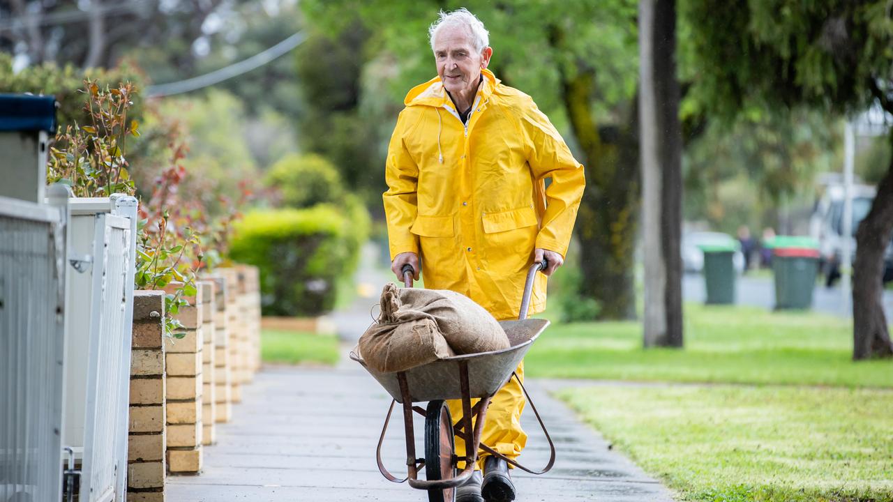 Barry, 82, works to protect his house in Rochester on the Campaspe River. Picture: Jason Edwards