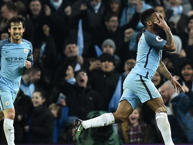 Manchester City's English midfielder Raheem Sterling (R) celebrates scoring his team's second goal during the English Premier League football match between Manchester City and Arsenal at the Etihad Stadium in Manchester, north west England, on December 18, 2016. / AFP PHOTO / Oli SCARFF / RESTRICTED TO EDITORIAL USE. No use with unauthorized audio, video, data, fixture lists, club/league logos or 'live' services. Online in-match use limited to 75 images, no video emulation. No use in betting, games or single club/league/player publications. /