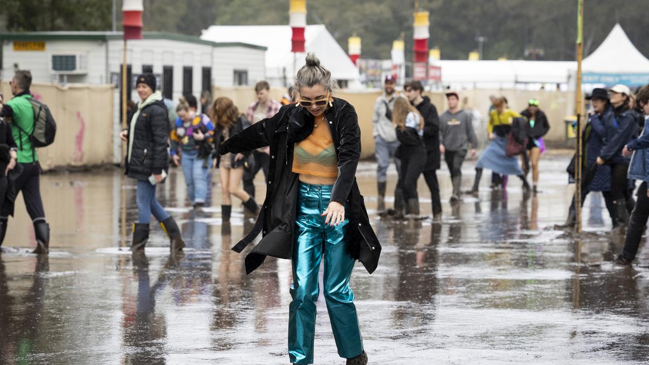 Revellers did their best to stay dry with gumboots as the rain relented on Saturday. (Photo by Matt Jelonek/Getty Images)