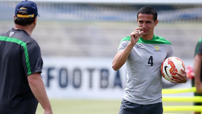 Tim Cahill has a laugh with coach Ange Postecoglou.