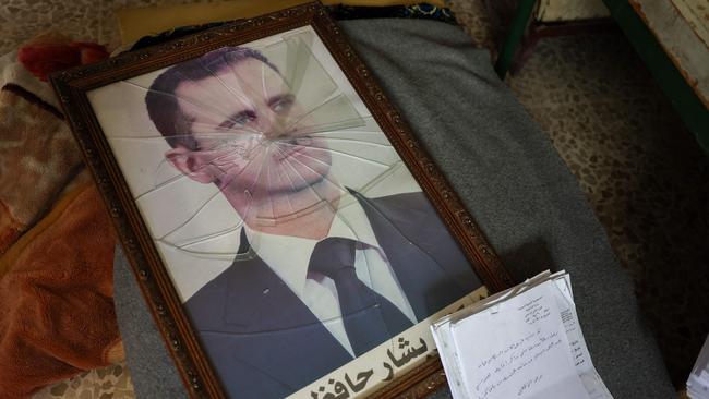 A portrait of Syrian president Bashar al-Assad in Hama, following the capture of the area by anti-government forces. Picture: AFP