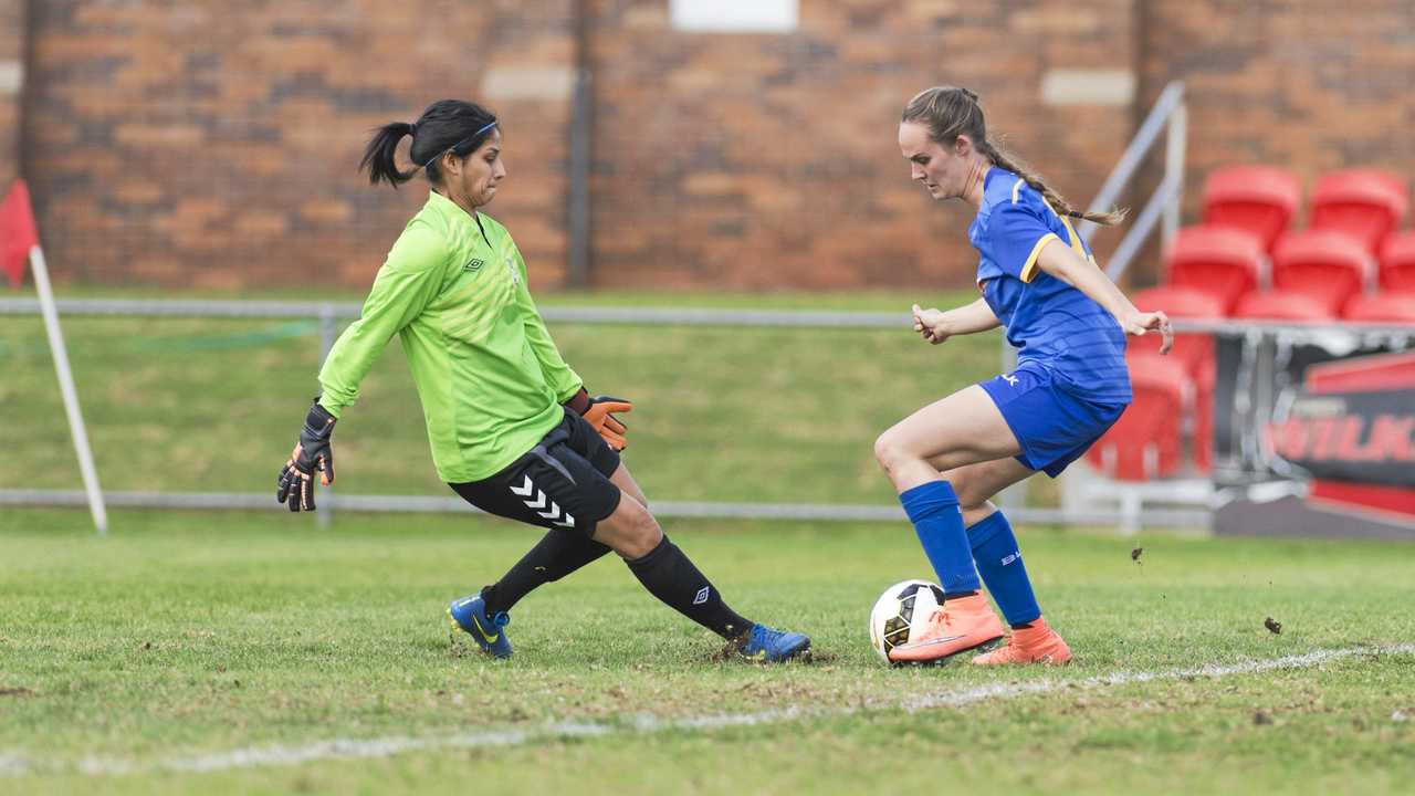 CALM ON THE BALL: Abbey Lloyd beats The Gap keeper Noran Abaza before going on to score. The former South West Queensland Thunder striker will face her old club when she lines up for Capalaba tomorrow. Picture: Kevin Farmer