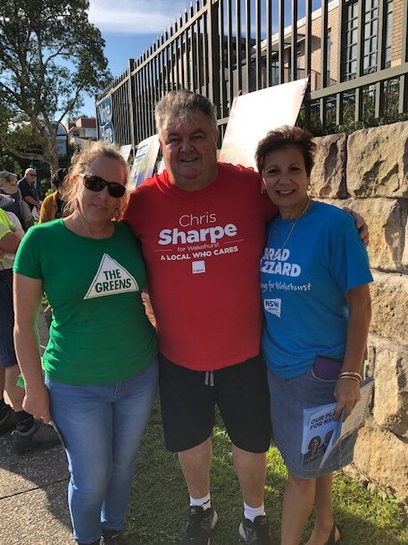 Labor candidate for Wakehurst, Chris Sharpe (centre), wishing election volunteers from the NSW Greens and Liberal Party luck at St Kevin’s Catholic School, Dee Why. 