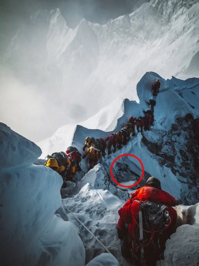 Climbers step over a dead body to get to the top — there are many fallen climbers unburied on the mountainside.