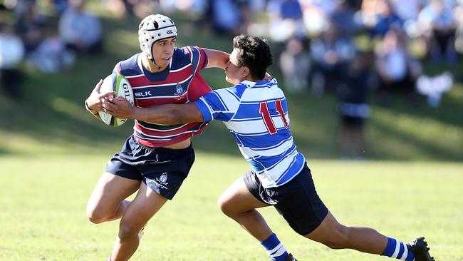 TSS fullback Dion Samuela fends off Nudgee’s Robert Mapa. Picture: Richard Gosling