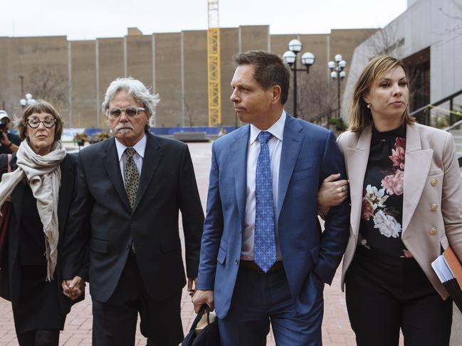 Justine Ruszczyk Damond’s family (from left) stepmother Maryan Heffernan, father John Ruszczyk, and fiance Don Damond (comforted by another Ruszcyck family member). Picture: Angus Mordant 