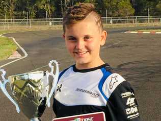 Max Acquasanta shows off his trophy and maroon winner's number plate after winning the State Cup in Cadet 12. Picture: Contributed