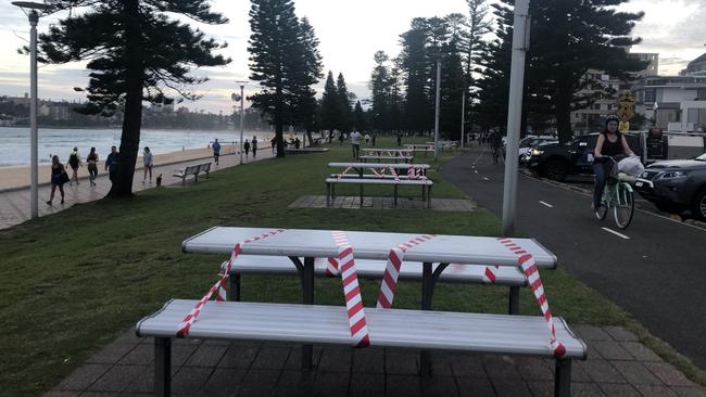 A row of taped up benches at Manly due to COVID-19 social distancing rules ahead of the long Easter weekend. Picture: Julie Cross