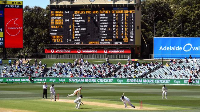 Australia's Pat Cummins fells India's Mohammed Shami with a bouncer as India is dismissed for 36 runs on the third day of the Adelaide Test