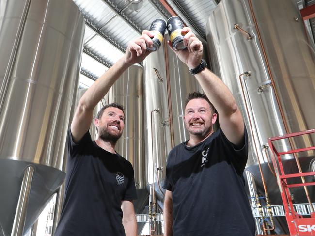 Black Hops Brewery has been so successful they've opened a second location in Biggera Waters. Owners Dan Norris and Michael McGovern toast future success at the plant. Picture Glenn Hampson