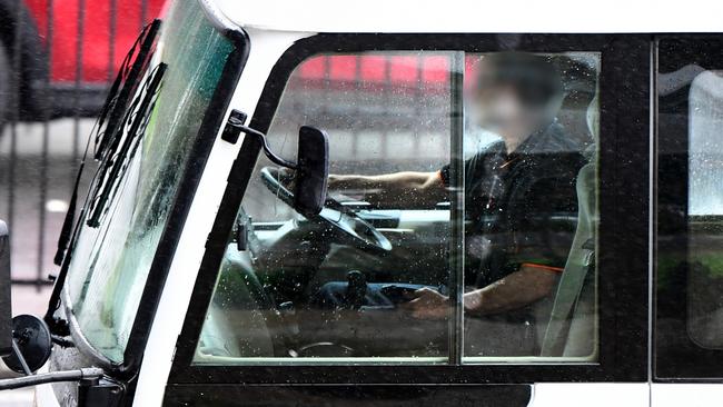 A bus holds his phone on his lap on South Rd while driving on Thursday. Picture: AAP /Mark Brake