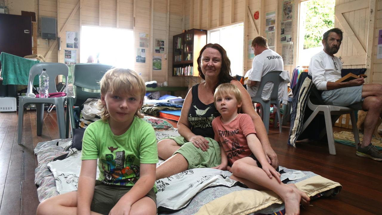 Tracy Walker with Tyler and Roman Archer evacuated to the Machans Beach Community Hall after their house was inundated by flood water.