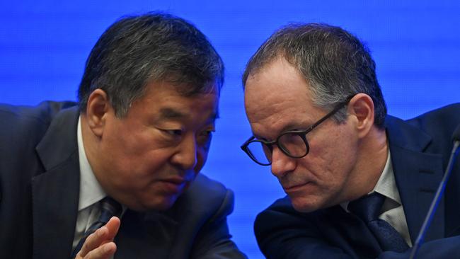 Peter Ben Embarek, right, talks with Liang Wannian. Picture: AFP