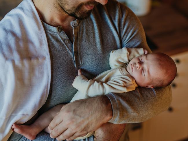 Close-up of father holding his little new born baby.