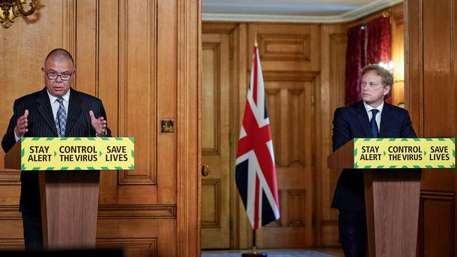 Britain’s deputy chief medical officer Jonathan Van-Tam (left) and Transport Secretary Grant Shapps attend a remote press conference to update the nation on coronavirus. Picture: AFP