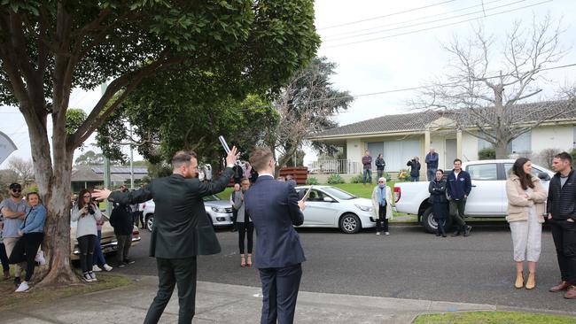 Prospective buyers attend a socially-distanced auction with Barry Plant Highton auctioneer Kieron Hunter. Picture: Peter Ristevski