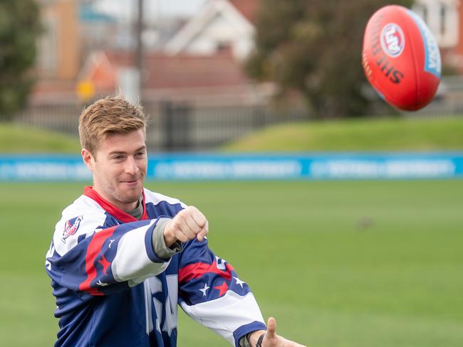 Team USA’s Tim Harrison handballs a footy at Western Bulldogs training. Picture: Jason Edwards