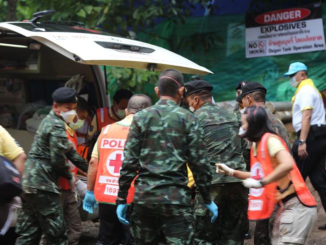 Thai soldiers and paramedics assist a rescued boy on a stretcher to an ambulance in Tham Luang cave area after divers evacuated some of the 12 boys and their coach trapped in the cave. Picture: AFP