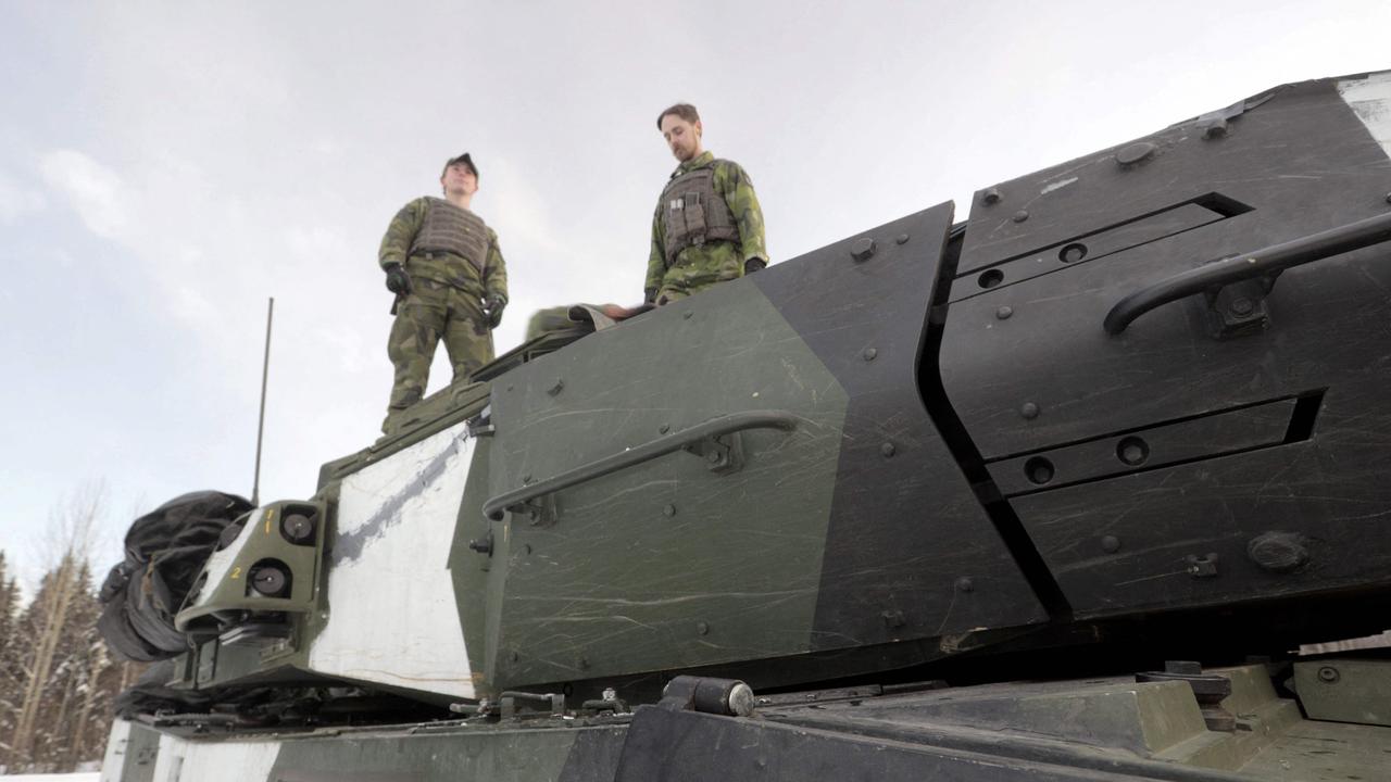 Soldiers stand on a Leopard 2 tank in Boden, Sweden. Picture: Sjolin /TT NEWS AGENCY / AFP