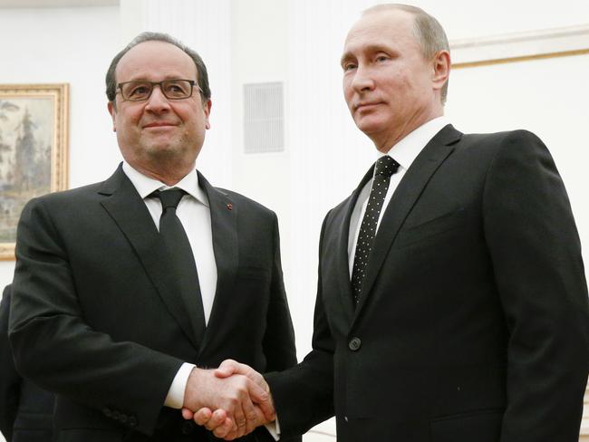 Russian President Vladimir Putin, right, shakes hands with his French counterpart Francois Hollande last year. Picture: AP Photo/Alexander Zemlianichenko