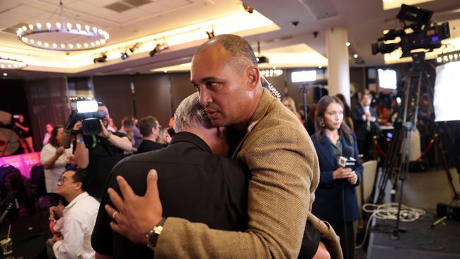 Thomas Mayo hugs Reverend Bill Crews at a Yes event at Wests Ashfield Leagues Club in Sydney. Picture: Damian Shaw