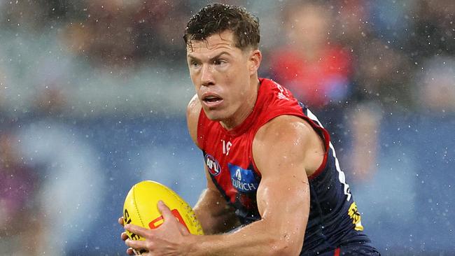 MELBOURNE, AUSTRALIA - JULY 13: Jake Melksham of the Demons runs with the ball during the round 18 AFL match between Melbourne Demons and Essendon Bombers at Melbourne Cricket Ground, on July 13, 2024, in Melbourne, Australia. (Photo by Kelly Defina/Getty Images)