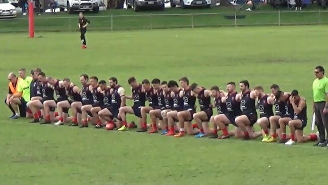 The three Indigenous Pooraka players were joined by their teammates in a moment of solidarity before the division-five grand final.