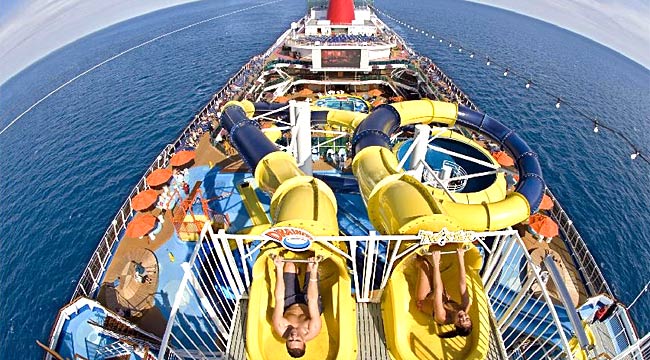 Passengers on the new Carnival Dream get ready to slide down two waterslides onboard the ship / Reuters