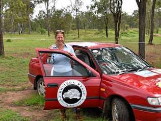 LET'S ROLL: Gatton lawyer Joanne Emery standing with 'The Little Red Devil', a Nissan Pulsar that she will be driving in the Shitbox Rally. Picture: Dominc Elsome