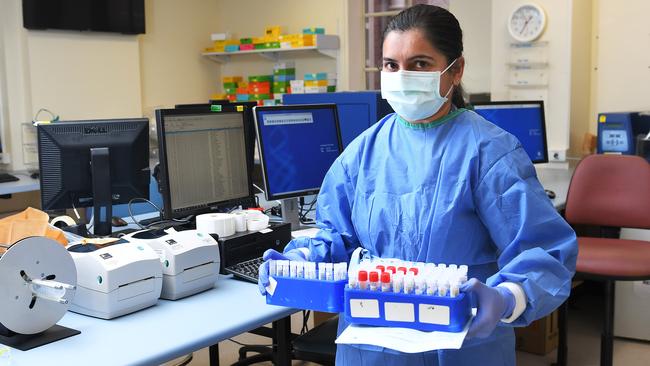 An SA Pathology scientists carries coronavirus samples at the laboratory on Frome Rd, Adelaide. Picture: Mark Brake