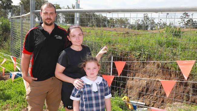 Raymond, Suzanne and their daughter Mia Phillips inspect the sinkhole on their street in Box Hill on Monday, February 24. Picture: AAP IMAGE / Angelo Velardo