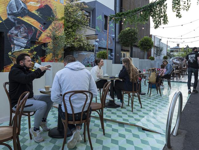 MELBOURNE, AUSTRALIA - OCTOBER 28: People are seen dining outside St. Ali Cafe in South Melbourne on October 28, 2020 in Melbourne, Australia. Lockdown restrictions in Melbourne lifted as of midnight with people able to leave their home for any reason. Cafes, restaurants, pubs and bars can reopen subject to patron limits while beauty services, tattoo parlours and any other service where you can wear a mask will be able to resume. Up to 10 people from any number of households will be able to gather outdoors, however, Victorians are still required to wear a face mask in public. Metropolitan Melbourne has been subject to Stage 4 restrictions since 2 August 2020 with residents under stay at home orders following a second wave of COVID-19 cases in the community. (Photo by Daniel Pockett/Getty Images)