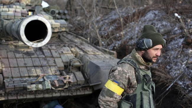 A servicemen of the Ukrainian Military Forces walks in front of a tank following fighting against Russian troops and Russia-backed separatists near Zolote village, Lugansk region. Picture: AFP