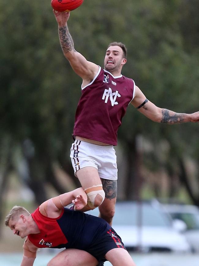 Nullawil ruckman Dean Putt climbs over his Wycheproof-Narraport opponent Lachlan Van Schaik.