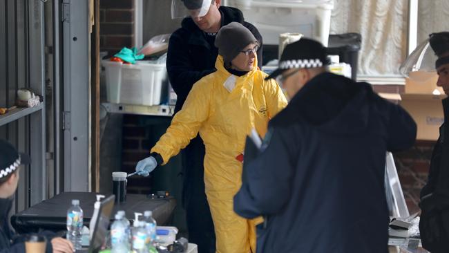 Detectives remove sophisticated drug production equipment from a clandestine drug laboratory, uncovered at Morphett Vale. Picture: Dean Martin