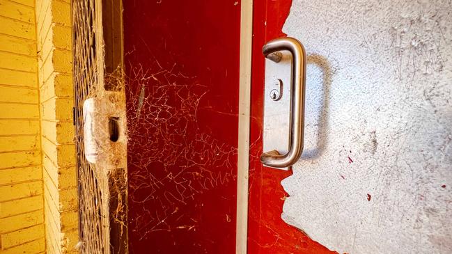 Door of the youth engagement centre, broken and covered in cobwebs. Picture: Emma Brasier