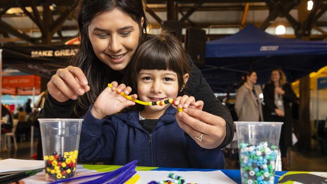 Brooklyn Gwilliams gets a hand from mum Shantelle Gwilliams on a craft stall at Toowoomba NAIDOC Week celebrations at The Goods Shed, Monday, July 4, 2022. Picture: Kevin Farmer