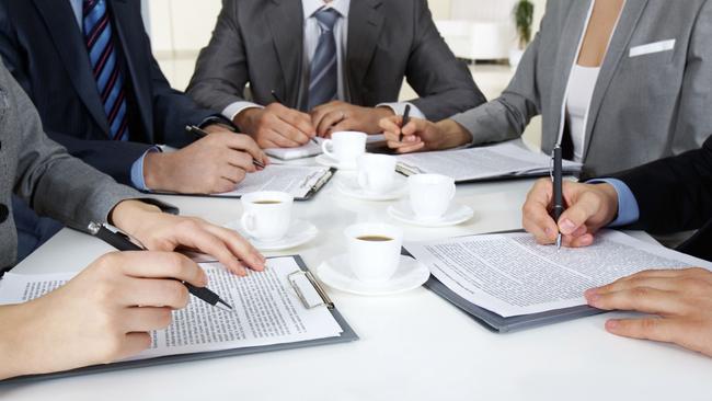 Generic pic of people seated around a table during a business meeting.