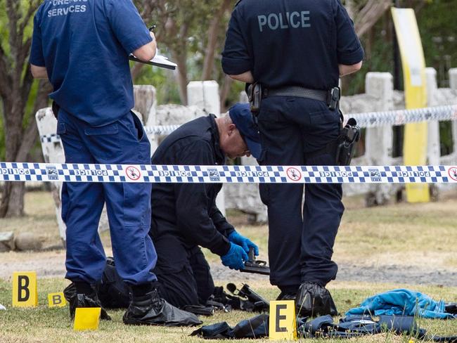 Police forensic officers examine the officers’ guns at the scene. Picture: Julian Andrews